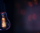 A burning lamp hangs in the dark on a blurred background. Space for text. High quality photo. A light bulb glows in the dark.