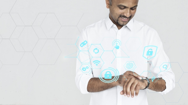 Indian man checking on his smartwatch